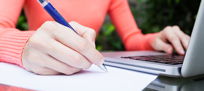 The hand of woman writing a document.