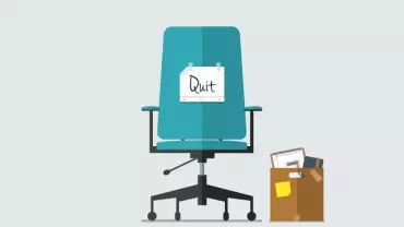 Office chair with 'Quit' sign and a box of belongings.