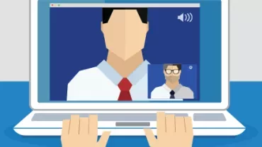 Laptop screen showing video call with two people in a meeting.