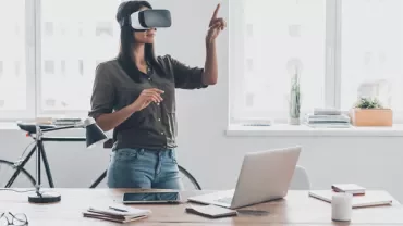 Woman using a VR headset in a modern office.