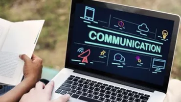 Laptop screen displaying communication icons with a person reading beside it.