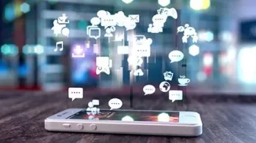 Smartphone on table with digital icons floating above.