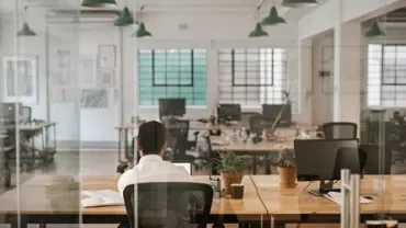 Person working alone in a modern, open office space.