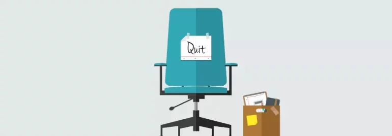Office chair with 'Quit' sign and a box of belongings.