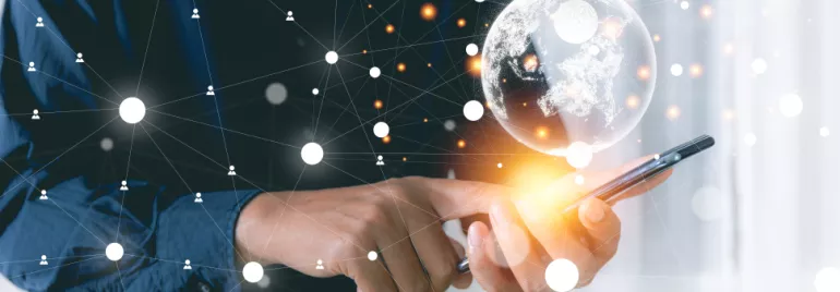 Person using smartphone with a glowing digital globe and network connections.