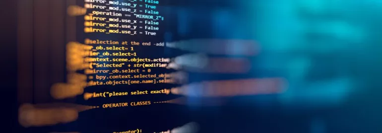 Close-up of colorful computer code on a blurred blue background.