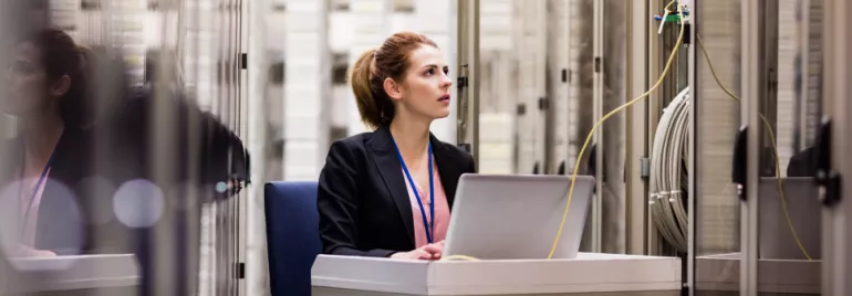 Woman sitting alone in a room with a laptop