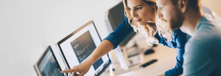 Woman and man sitting in front of computer