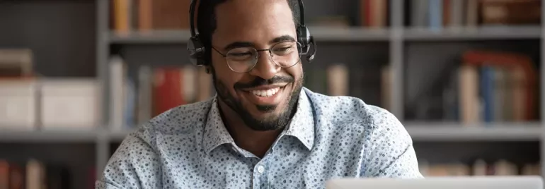 Man smiling looking at his laptop