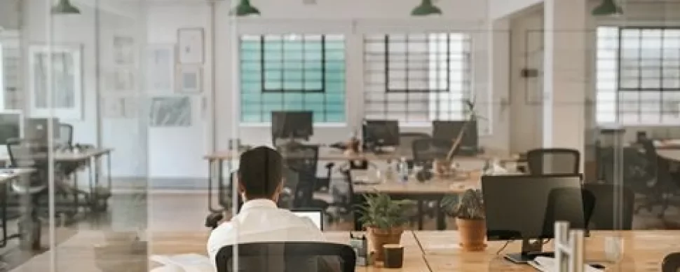Person working alone in a modern, open office space.