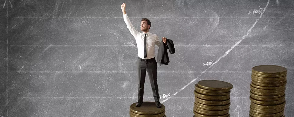Man standing on coins, chalkboard graph in background