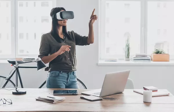Woman using a VR headset in a modern office.